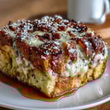 Monte Cristo Breakfast Casserole slice showing melty Swiss cheese, ham, and turkey layers.