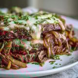 Topped with gooey Gruyère and fresh parsley, served in a rich, savory red wine jus.