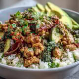 Hearty ground turkey bowl garnished with avocado slices, fresh cilantro, and bright lime wedges.