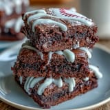Delicious brownie bites decorated with white icing laces to look like baseballs, perfect for game day celebrations and sports-themed parties.