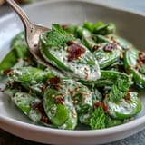 Crisp snap pea and radish spring salad, perfect with toasted sesame seeds.