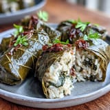 Kurdish Dolma: perfectly rolled grape leaves stuffed with aromatic herbed rice.