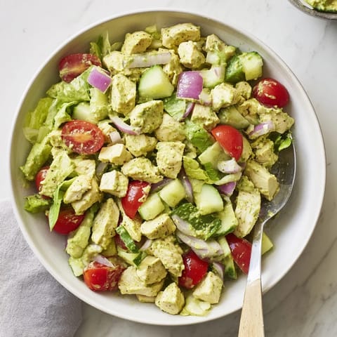 Tender diced chicken breast mixes with avocado ranch, crunchy celery, and red onion on a bed of romaine, perfect for a light, refreshing lunch.
