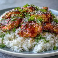Honey Garlic Chicken with Rice in a slow cooker, served over fluffy jasmine rice with a glossy honey garlic glaze.